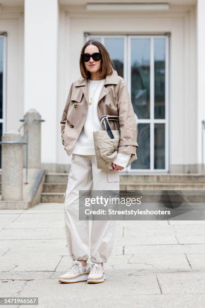 Influencer and style icon Annette Weber, wearing beige cargo pants by Second Female, a dark beige trench jacket by Max Mara, a white cashmere...