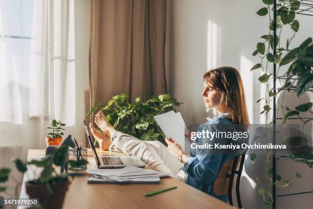 top view close up woman calculating bills, money, loan or rent payments, using laptop, online banking service, sitting at table, female holding receipt, planning budget, managing expenses, finances - energy bill stock pictures, royalty-free photos & images