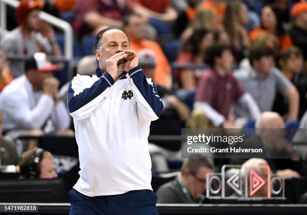 Head coach Mike Brey of the Notre Dame Fighting Irish directs his team against the Virginia Tech Hokies during the first half in the first round of...