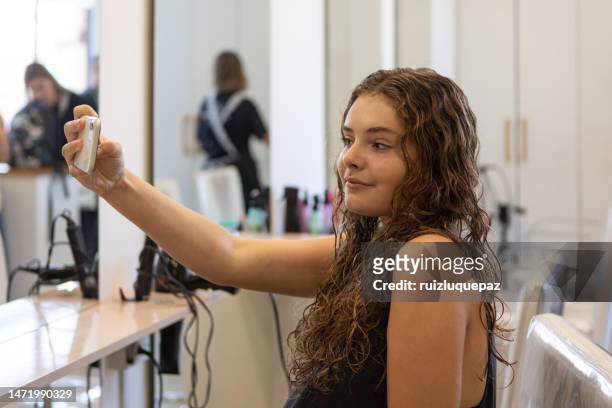teenager taking a selfie at hair salon - argentina girls stock pictures, royalty-free photos & images