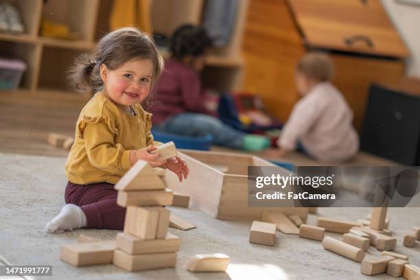 little girl playing with blocks - daycare stock pictures, royalty-free photos & images