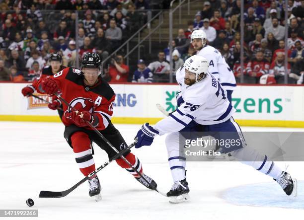 Brodie of the Toronto Maple Leafs clears the puck from Ondrej Palat of the New Jersey Devils during the second period at Prudential Center on March...