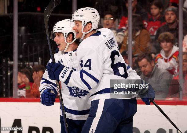 Mitchell Marner of the Toronto Maple Leafs celebrates his goal with teammate David Kampf during the third period at Prudential Center on March 07,...