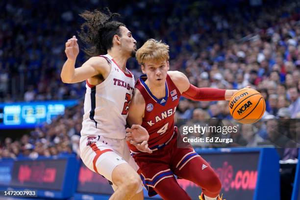 Gradey Dick of the Kansas Jayhawks drives against Pop Isaacs of the Texas Tech Red Raiders in the first half at Allen Fieldhouse on February 28, 2023...