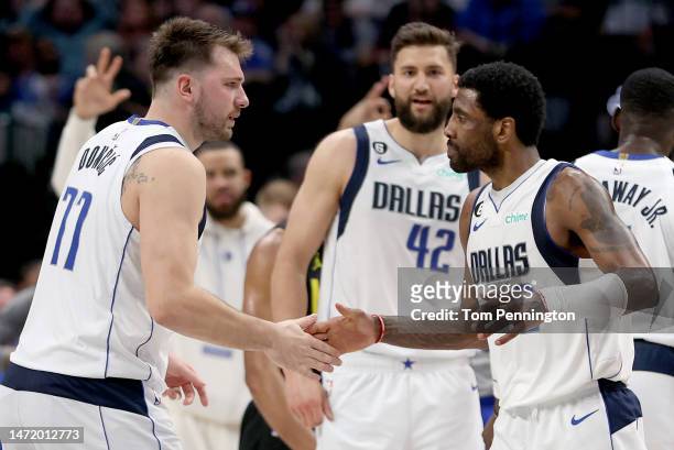 Kyrie Irving of the Dallas Mavericks celebrates with Luka Doncic of the Dallas Mavericks after scoring against the Utah Jazz in the fourth quarter at...