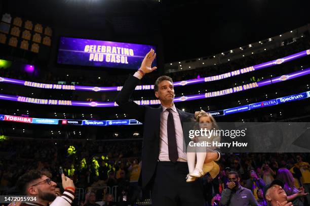 Pau Gasol of the Los Angeles Lakers waves to applause holding daughter Elisabet Gianna, before his jersey retirement ceremony at halftime in the game...