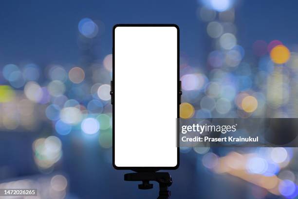 mockup of blank white screen of smartphone in concert background. - smart phone camera stock pictures, royalty-free photos & images