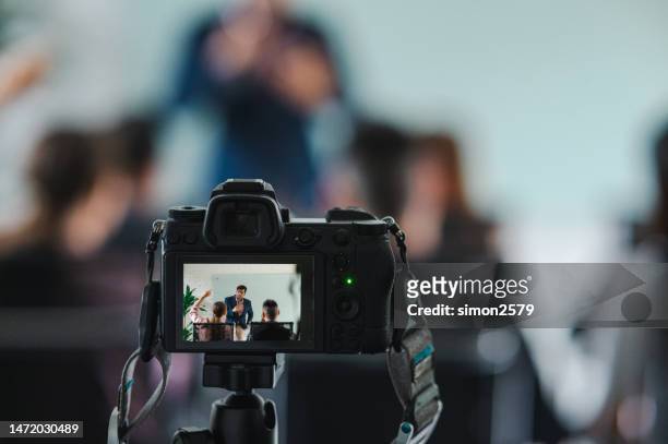 recording a video during seminar - press conference cameras stock pictures, royalty-free photos & images