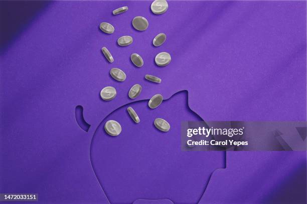 old coins fall on piggy bank. - jackpot stock-fotos und bilder