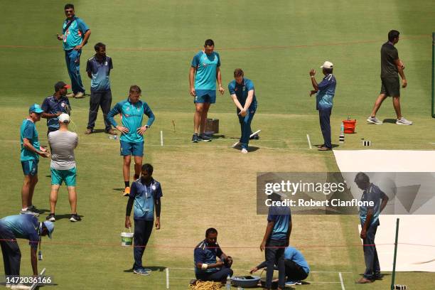 Steve Smith, Scott Boland and Todd Murphy inspect the pitch prior to an Australia Test squad training session at Narendra Modi Stadium on March 08,...