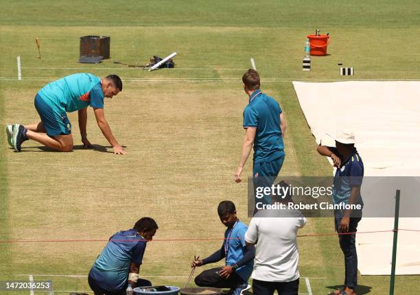 Scott Boland of Australia inspects the pitch prior to an Australia Test squad training session at Narendra Modi Stadium on March 08, 2023 in...