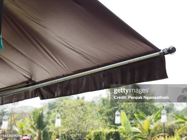 canvas awning brown color - sonnensegel stock-fotos und bilder