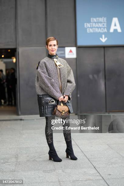 Guest wears a black and gold embroidered tweed with black shiny leather details and gold large zipper jacket from Louis Vuitton, black mesh / fishnet...