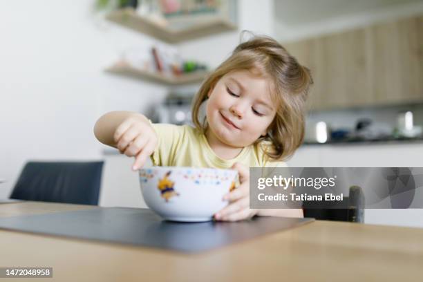 todler girl enjoys eating noodle soup - noodle soup stock pictures, royalty-free photos & images