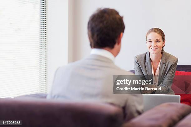 business people talking face to face in lobby - face to face interview stock pictures, royalty-free photos & images