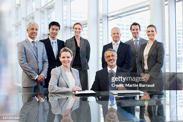 portrait of smiling business people in conference room - medium group of people stock pictures, royalty-free photos & images