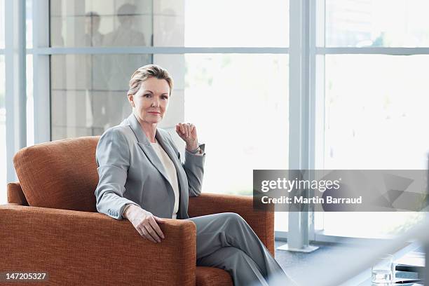 portrait of confident businesswoman in armchair - chaise lounge bildbanksfoton och bilder