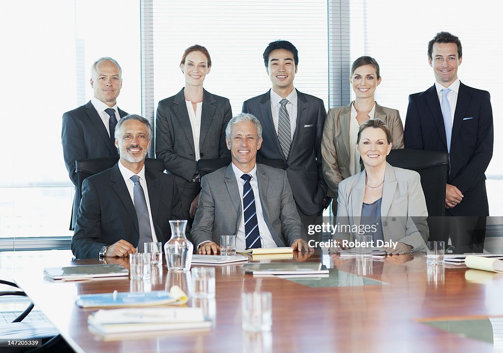 Portrait of smiling business people in conference room