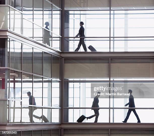 businessmen walking along corridor in modern office - röra mot bildbanksfoton och bilder