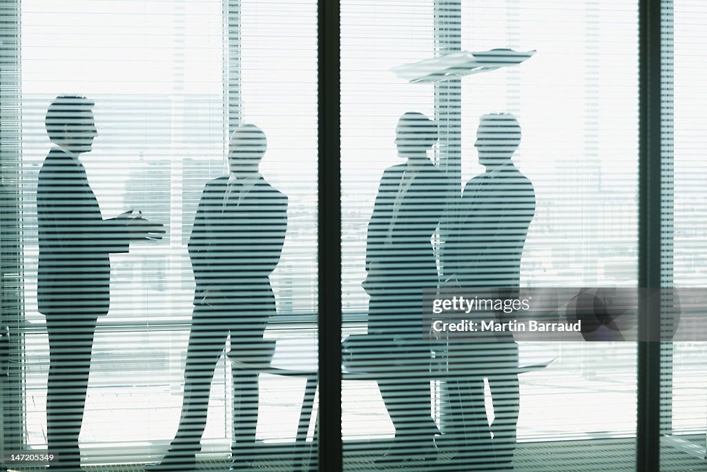 Silhouette of business people talking in conference room