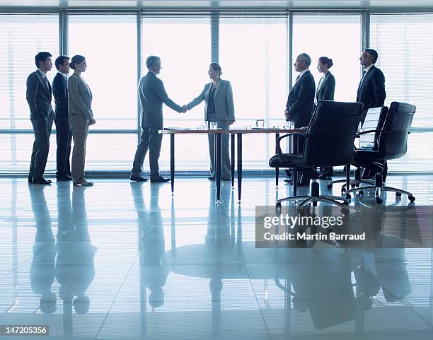 business people shaking hands in conference room - takeover stock pictures, royalty-free photos & images