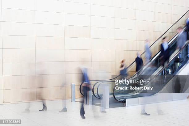 business people on escalators - medium group of people stock pictures, royalty-free photos & images