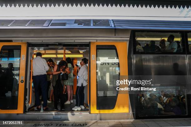 Commuters board a train at Central Station on March 08, 2023 in Sydney, Australia. Sydney trains ground to a halt shortly before the afternoon peak...