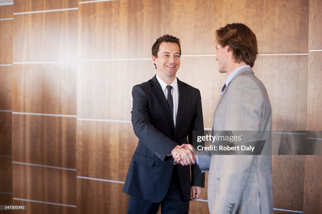 Smiling businessmen shaking hands