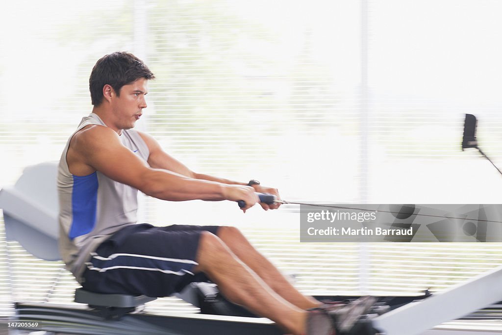 Man Using Rowing Machine In Gymnasium High-Res Stock Photo - Getty Images