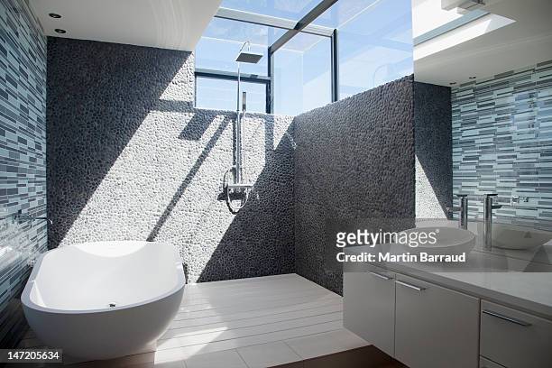 sun shining through window in modern bathroom - luxury bathroom stock pictures, royalty-free photos & images