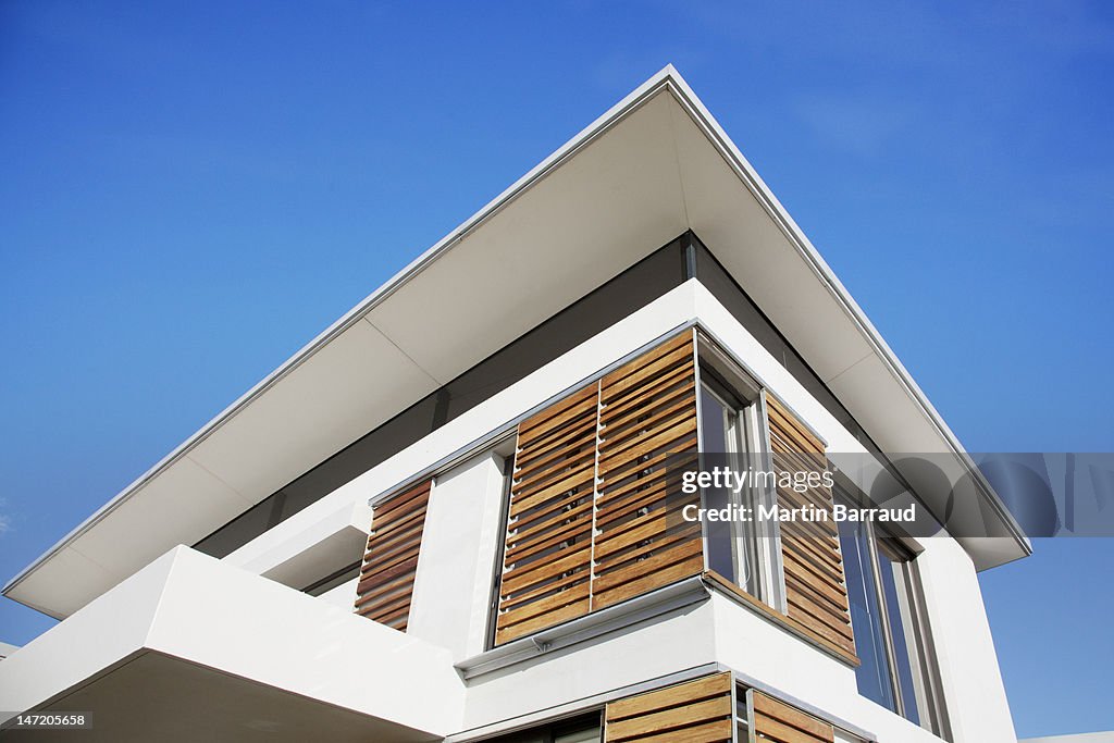 Low angle view of wood shutters on modern house