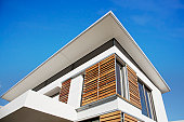 Low angle view of wood shutters on modern house
