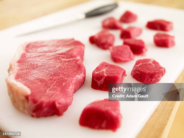 cubed raw steak on cutting board - red meat stock pictures, royalty-free photos & images