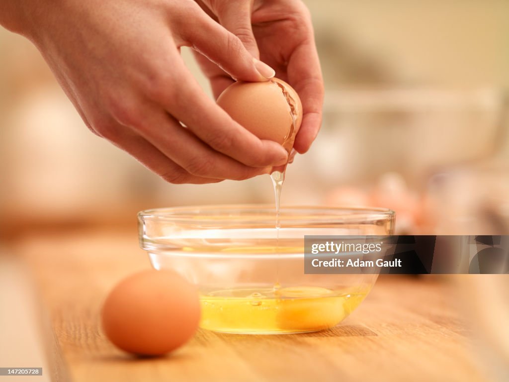 Woman cracking egg
