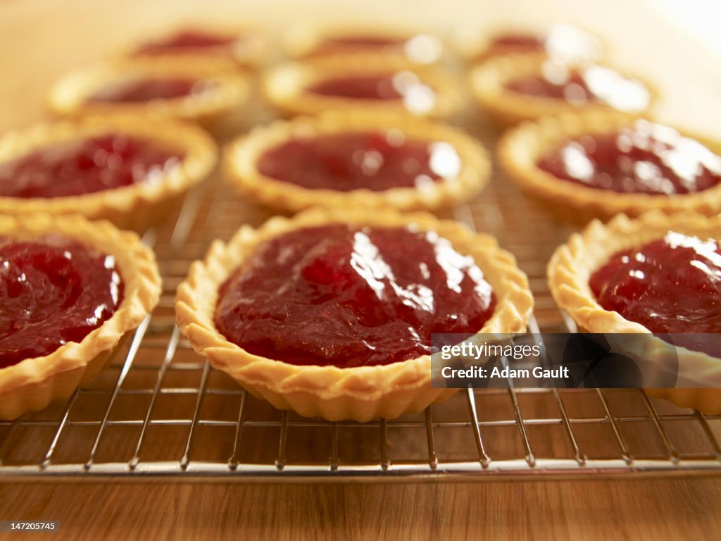 Close up of jam tarts cooling on wire rack