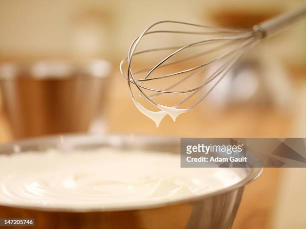 close up of wire whisk over bowl of cream - wire whisk ストックフォトと画像