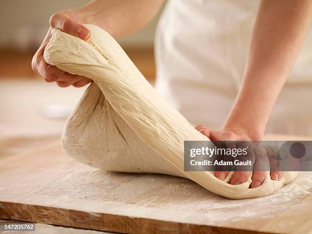 woman kneading dough - teig kneten stock-fotos und bilder