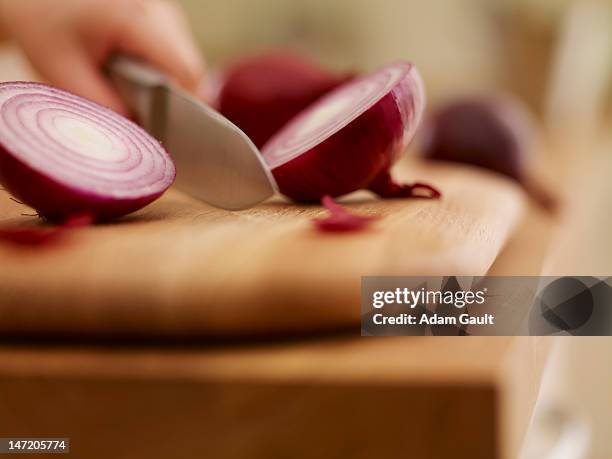 knife chopping red onion on cutting board - cutting red onion stock pictures, royalty-free photos & images