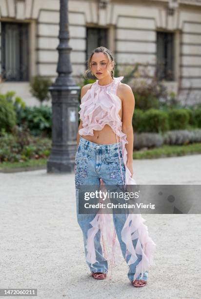 Carla Ginola wears rose pink ruffled blouse, embroidered denim jeans, heeled sandals outside Zimmermann during Paris Fashion Week - Womenswear Fall...