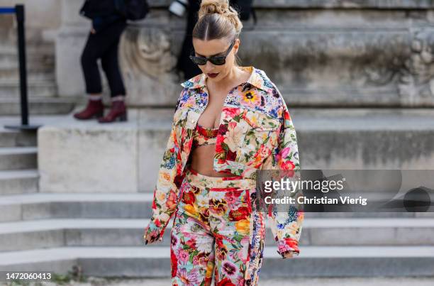 Veronica Ferraro wears floral print jacket, cropped top, pants, sunglasses outside Zimmermann during Paris Fashion Week - Womenswear Fall Winter 2023...