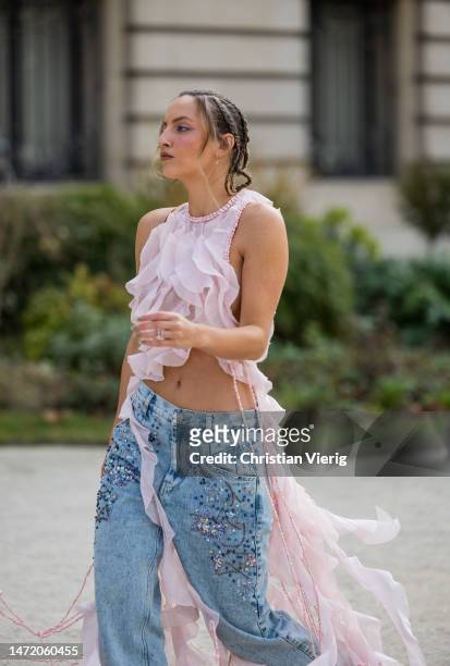 Carla Ginola wears rose pink ruffled blouse, embroidered denim jeans, heeled sandals outside Zimmermann during Paris Fashion Week - Womenswear Fall...