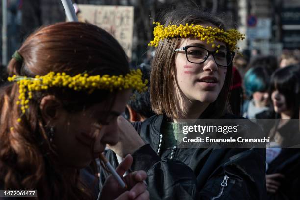 Students and feminist activists wearing mimosa crowns take part in a rally, demonstrating against gender violence and calling for free and safe...