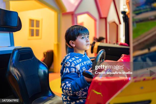 having fun with amusement arcade game - lost stock pictures, royalty-free photos & images
