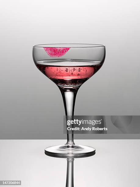 close up of pink champagne in glass with lipstick stain - pink lipstick smear stock pictures, royalty-free photos & images