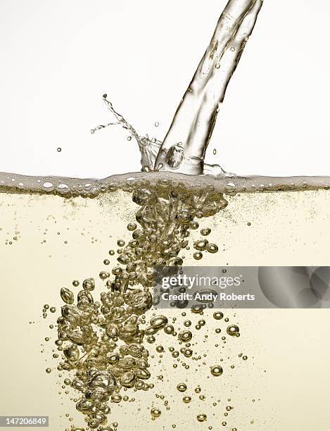 close up of champagne being poured - bulles champagne photos et images de collection