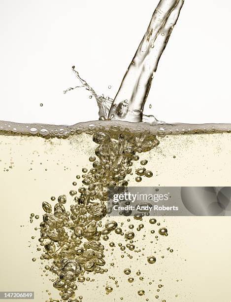 close up of champagne being poured - wine splashing stock pictures, royalty-free photos & images