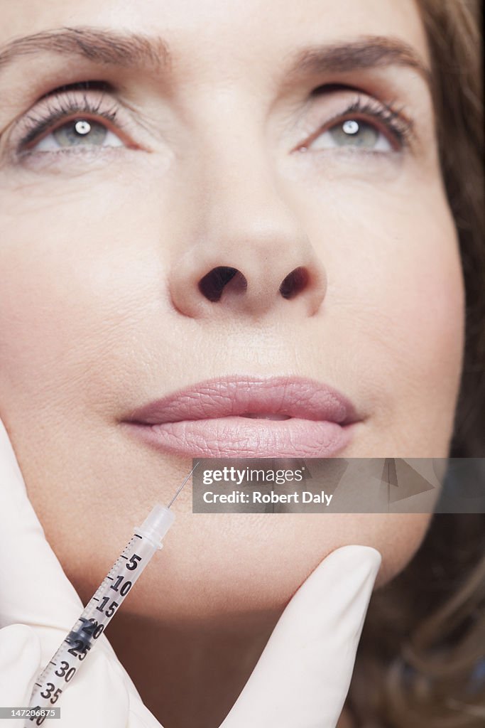 Close up of woman receiving botox injection