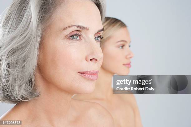 close up of bare chested mother and daughter - beautiful woman headshot studio stock pictures, royalty-free photos & images