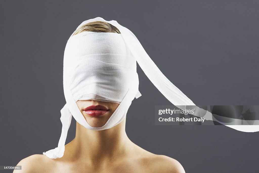 Bandage covering woman's face