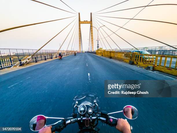 riding bike over highway bridge - howrah bridge stock pictures, royalty-free photos & images